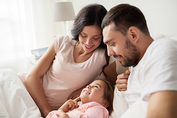 Image showing happy family in bed at home