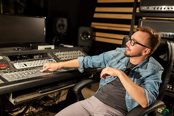 Image showing man at mixing console in music recording studio