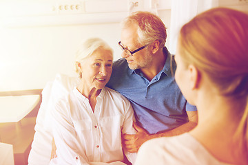 Image showing happy family visiting senior woman at hospital