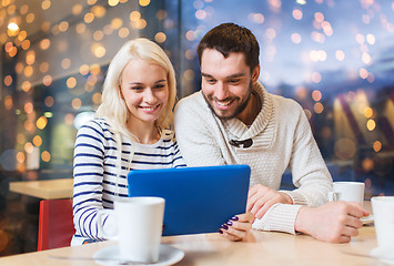 Image showing happy couple with tablet pc and coffee at cafe