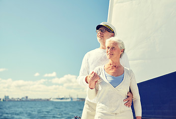 Image showing senior couple hugging on sail boat or yacht in sea