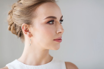 Image showing face of woman in white dress with diamond jewelry