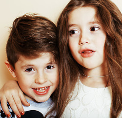 Image showing little cute boy and girl hugging playing on white background, ha