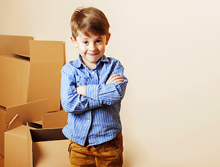 Image showing little cute boy in empty room, remoove to new house. home alone,