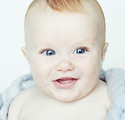 Image showing little cute red head baby in scarf all over him close up isolate