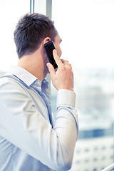 Image showing businessman calling on smartphone in office