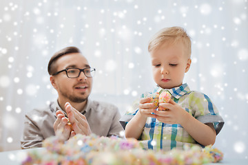 Image showing father and son playing with ball clay at home