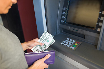 Image showing close up of hand withdrawing money at atm machine