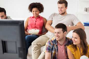 Image showing happy friends watching tv at home