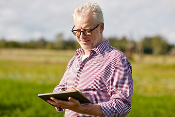 Image showing senior man with tablet pc computer at county