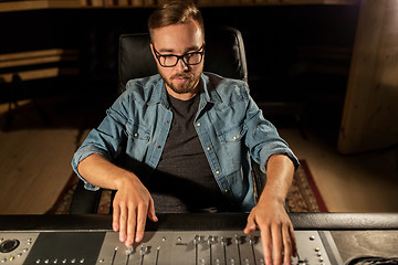 Image showing man at mixing console in music recording studio