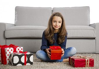 Image showing Little girl opening presents