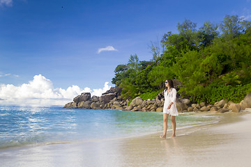 Image showing A beautiful woman walking on the beach