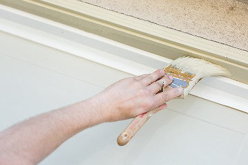 Image showing Professional Painter Cutting In With Brush to Paint Garage Door 