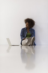 Image showing african american woman sitting on floor with laptop