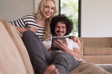 Image showing couple relaxing at  home with tablet computers