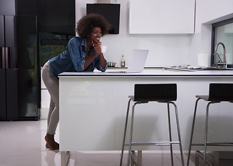 Image showing smiling black woman in modern kitchen