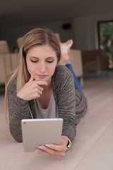 Image showing young women used tablet computer on the floor