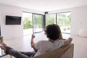 Image showing Rear view of couple watching television