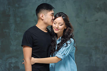 Image showing Portrait of smiling Korean couple on a gray