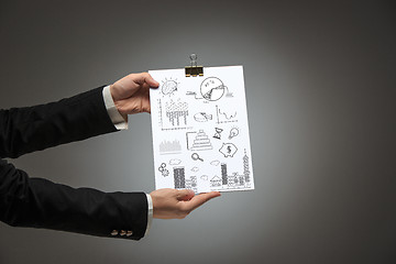 Image showing Male hands holding business plan