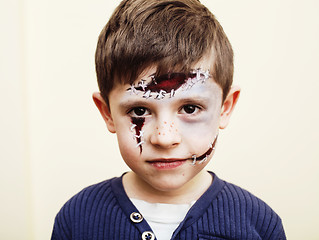 Image showing little cute boy with facepaint like zombie apocalypse at hallowe