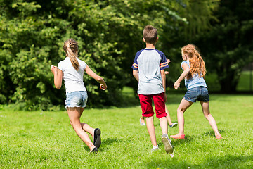 Image showing group of happy kids or friends playing outdoors