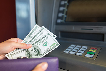 Image showing close up of hand withdrawing money at atm machine