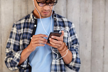 Image showing man with earphones and smartphone listening music