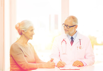 Image showing smiling senior woman and doctor meeting