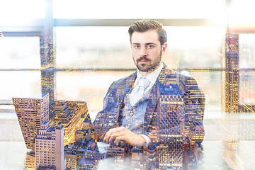 Image showing Businessman in office working on laptop computer.