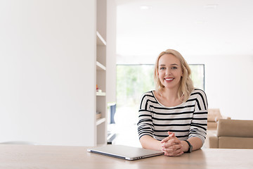 Image showing Young woman with laptop at home