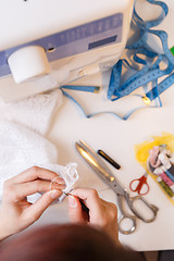 Image showing Young girl engaged in needlework