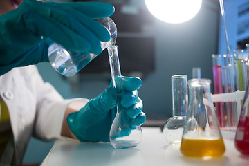 Image showing Lab assistant carries chemical experiments