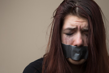 Image showing Crying woman with gray tape