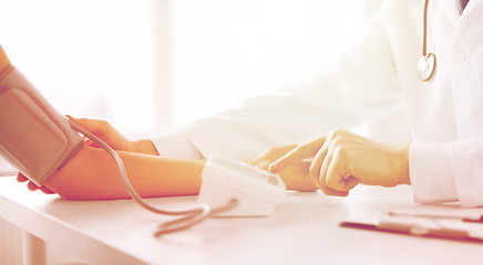 Image showing doctor and patient measuring blood pressure