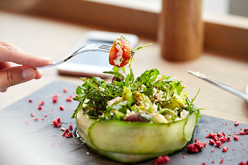 Image showing woman eating cottage cheese salad at restaurant