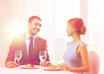 Image showing smiling couple eating main course at restaurant