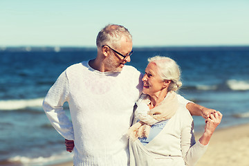 Image showing happy senior couple hugging on summer beach