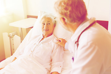 Image showing doctor visiting senior woman at hospital ward