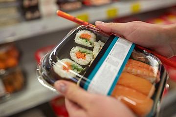 Image showing hands with sushi pack at grocery or supermarket