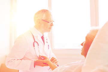 Image showing doctor checking senior woman pulse at hospital