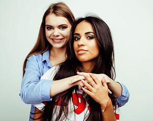 Image showing best friends teenage girls together having fun, posing emotional on white background, besties happy smiling, lifestyle people concept, blond and brunette multi nations 