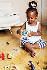 Image showing little cute african american girl playing with animal toys at ho