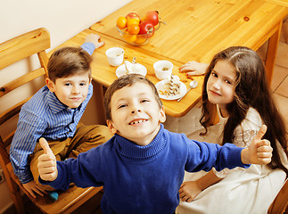 Image showing little cute boys eating dessert on wooden kitchen. home interior. smiling adorable friendship together forever friends, lifestyle people concept