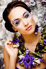 Image showing floral face art with anemone in jewelry, sensual young brunette 