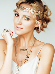 Image showing young blond woman dressed like ancient greek godess, gold jewelry close up isolated