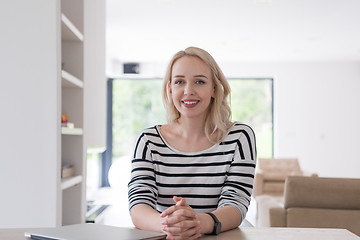 Image showing Young woman with laptop at home