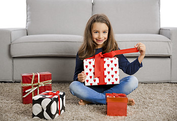 Image showing Little girl opening presents