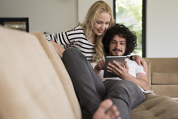 Image showing couple relaxing at  home with tablet computers